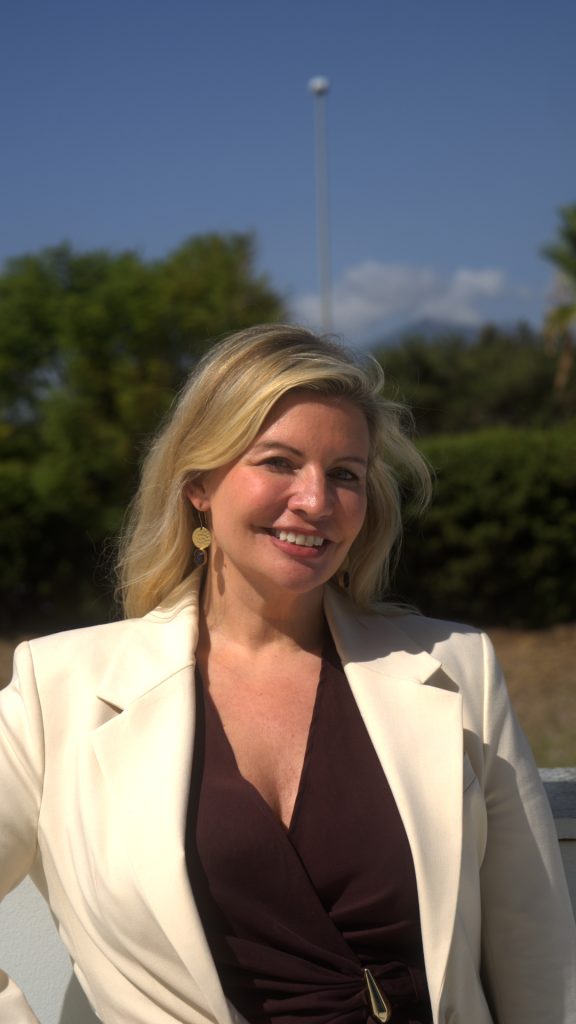 Close-up portrait of Caroline Lips, founder of Get Visible, smiling in a cream blazer
